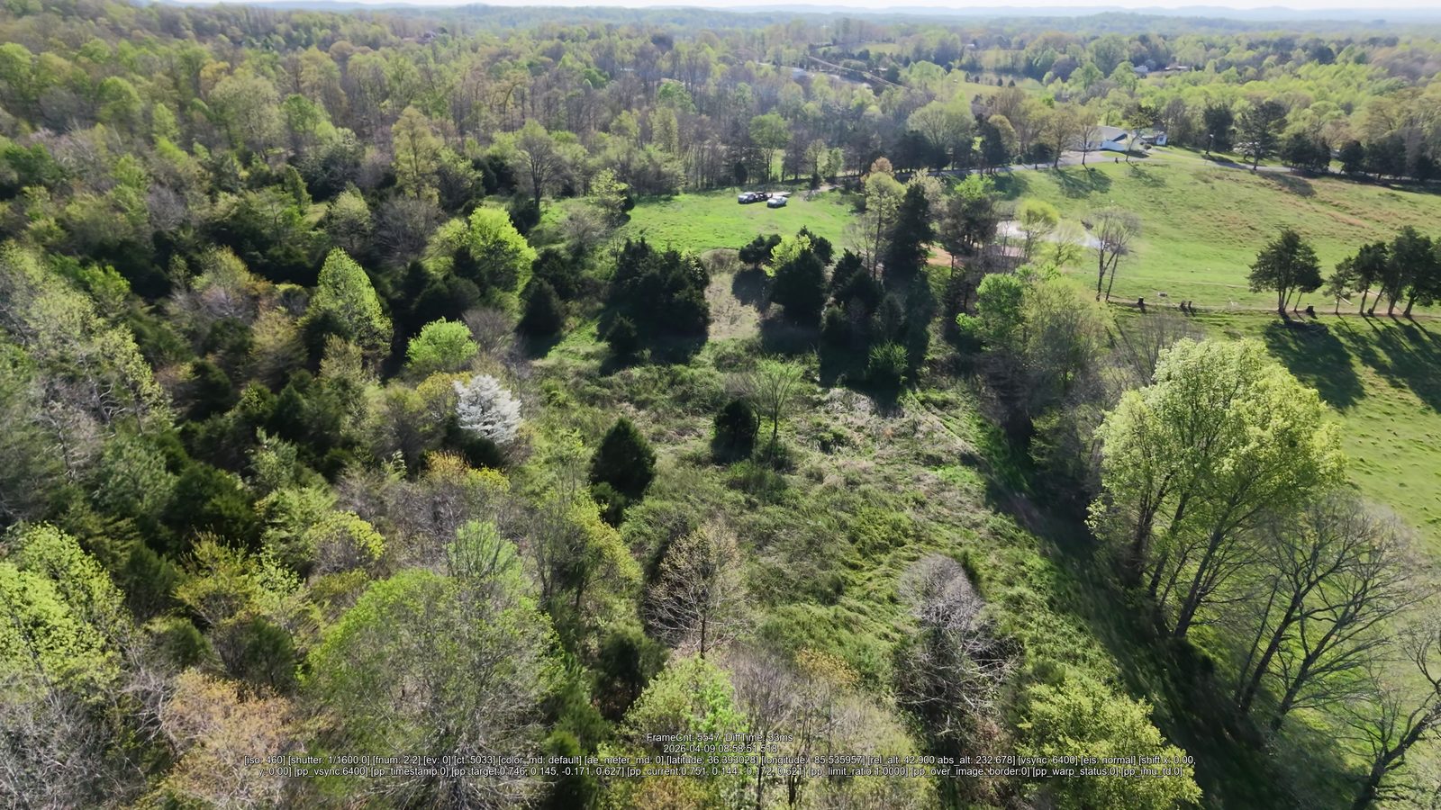 Aerial view of cleared acreage with remaining mature trees and pasture edges