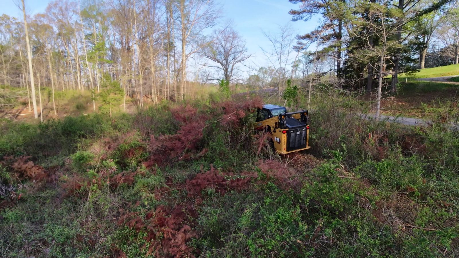 CAT 275-05 compact track loader mid-mulch on a Putnam County clearing job