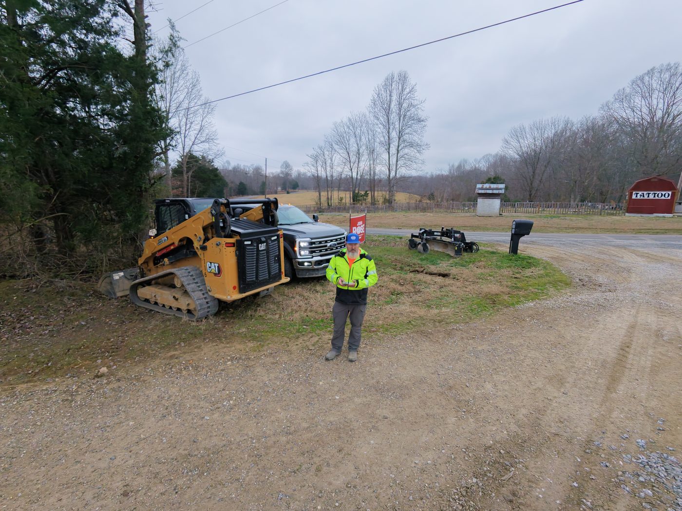 Richard, owner of Precision Grading Specialists, on a PGS jobsite with a CAT compact track loader