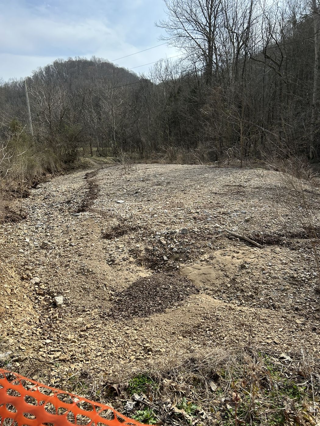 Pleasant Valley site after grading with cleared pad and hillside backdrop