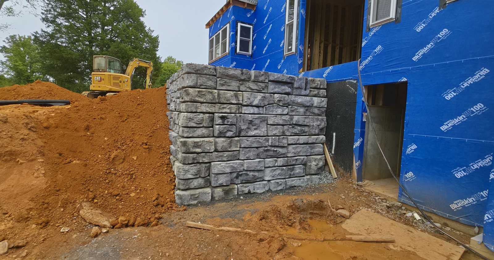 L-shaped Redi-Rock retaining wall, 12-foot and 8-foot legs, about 8 feet tall, in Gainesboro, Tennessee, built by Precision Grading Specialists